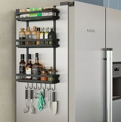 a stainless steel refrigerator with shelves holding various kitchen items and utensils on it