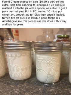 four jars filled with white liquid sitting on top of a counter next to each other