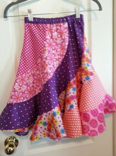 a skirt hanging on a door with polka dots and flowery fabric in the front