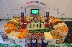 a football stadium food spread with snacks and drinks on the sidelines at a party