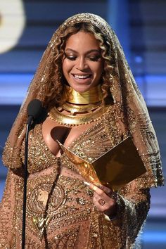 the singer is smiling as she accepts an award