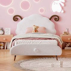 a child's bedroom with pink walls and white bedding, teddy bear on the headboard