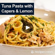 the video shows how to make tuna pasta with capers and lemon in a white bowl