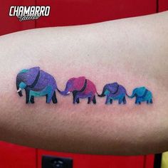 an arm with three elephants on it and the word love is written in different colors