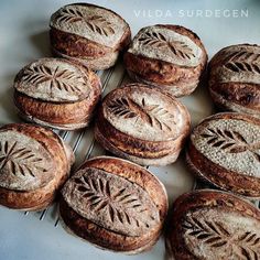 several loaves of bread sitting on top of a cooling rack