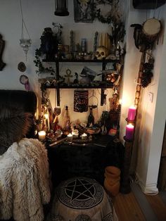 a room filled with lots of decorations and candles on the wall next to a bed