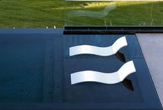 an image of a logo on the side of a building with grass in the background