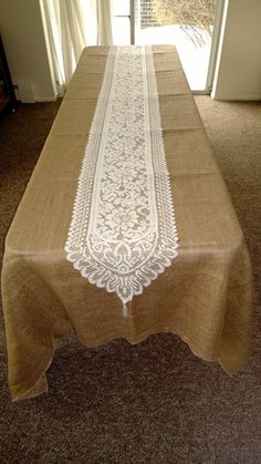 an image of a table setting with white lace on the top and tan linens