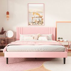 a pink bed in a white room with two mirrors and a rug on the floor