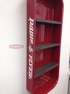 a red metal shelf with two shelves on each side and the word texas painted on it