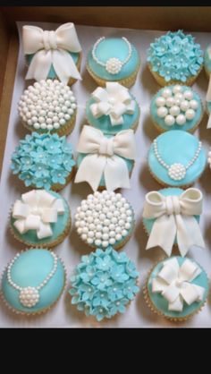 a box filled with cupcakes covered in frosting