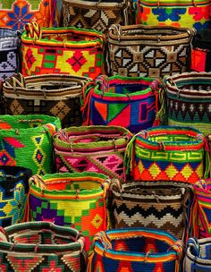 many colorful baskets are stacked on top of each other