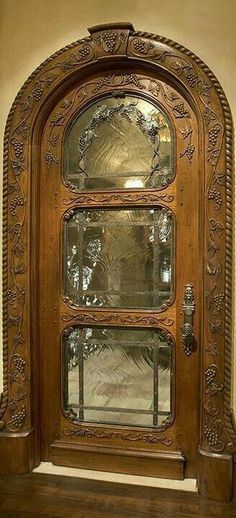 an ornate wooden door with glass inserts