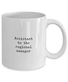 a white coffee mug with the words assistant to the regional manager in black on it