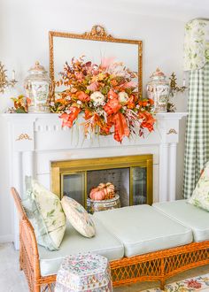 a living room filled with furniture and flowers on top of a fireplace mantel in front of a mirror