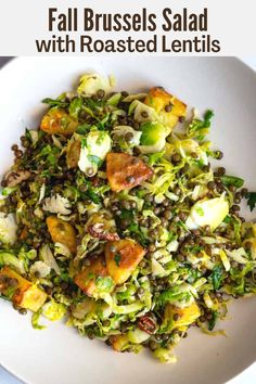 a white plate topped with brussels sprouts and other vegetables