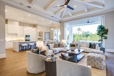 a living room filled with furniture and a ceiling fan