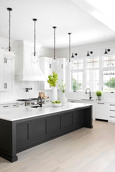 the instagram page on instagram shows an image of a kitchen with white cabinets and black island