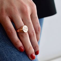 a close up of a person's hand wearing a gold ring with the word love on it