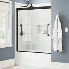 a bathroom with blue walls and white tile on the floor, including a walk in shower