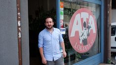 a man standing in the doorway of a store