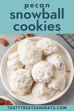 a bowl filled with snowball cookies on top of a table