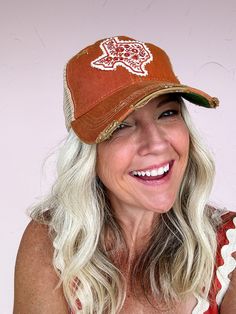 A perfect patch for a perfect state! This beautiful and fun hat features an embroidered Texas patch with floral design on a burnt orange background. Slight distressing gives this one a vintage inspired, worn-in feel that you'll love right from the start! Perfect for those Texas Longhorn fans! Handmade patch designed and made in Texas Distressed 'old favorite' style hat Snapback feature ensures a perfect fit Distressed Brown Vintage Hat, Casual Brown Hat With Embroidered Patch, Distressed Brown Summer Hat, Casual Brown Hat With Patches, Distressed Brown Trucker Baseball Cap, Vintage Distressed Trucker Hat, Vintage Brown Trucker Hat For Spring, Distressed Brown Snapback Trucker Hat, Brown Distressed Snapback Trucker Hat