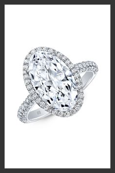 an oval shaped diamond ring with diamonds surrounding it