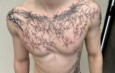 a man's chest is covered with vines