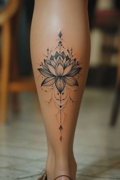 a woman's leg with a lotus tattoo on the lower part of her body