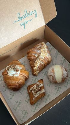 four pastries are in a box on the table