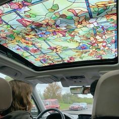 the interior of a car with a colorful glass skylight in the center and back window