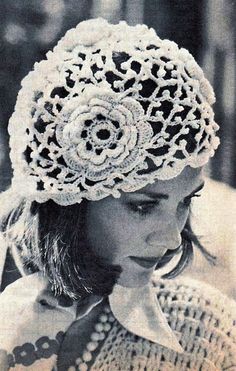 an old photo of a woman wearing a crocheted hat with flowers on it