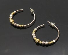 DYADEMA 925 Silver - Vintage Shiny Two Tone Beaded Hoop Earrings - EG9758  DYADEMA 925 Silver - Vintage Shiny Two Tone Beaded Hoop Earrings - EG9758  Jewelry Type:         Earrings   Metal Type:            925 Silver  Metal Size:             1.25"  Stone Type:            N/A  Condition:              N/A  Jewelry Weight:     4.1 Grams  PLEASE NOTE: THIS ITEM IS PRE-OWNED. ALTHOUGH MOST ITEMS ARE IN VERY GOOD CONDITION, SOME MAY NEED CLEANING AND/OR MINOR REPAIRS. WE MAKE A VERY STRONG EFFORT TO U Silver Beaded Hoop Earrings As Gift, Gift Hoop Earrings With Silver Beads, Hoop Silver Bead Jewelry Gift, Hoop Silver Beads Jewelry Gift, Silver Beads Hoop Jewelry For Gift, Hoop Earrings With Silver Beads, Clear Pictures, Earrings Metal, Beaded Hoop Earrings