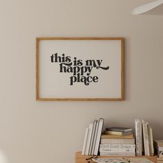 this is my happy place framed art print on the wall above a desk with books