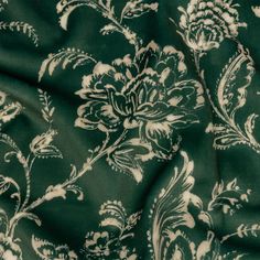 a green and white floral print fabric with an intricate design on the front, in full view