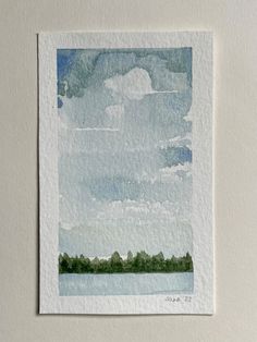 a watercolor painting of clouds and trees on a white paper with a blue sky in the background