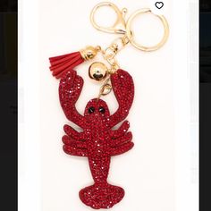 a red lobster keychain with a tassel hanging from it's side