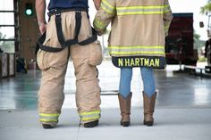 a fireman and a woman holding hands