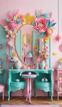 a room with pink and blue furniture and flowers on the wall, mirror and table