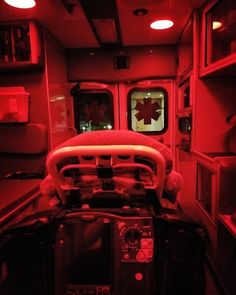 the inside of an ambulance with red lights and medical equipment on it's side