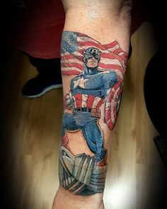 a man's arm with an american flag and a captain america tattoo on it