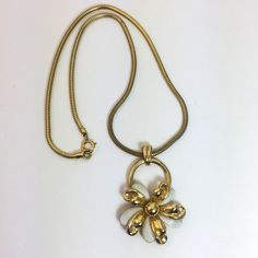 Beautiful vintage gold tone metal chain necklace with a flower pendant. - 16 inches long - The pendant is 1 5/8" tall and 1 1/4 inches wide. Gold tone and white petals. - Lobster claw closure in the back. - Very good vintage condition. I offer free shipping for this item. Vintage White Chain Necklace Gift, Vintage White Chain Necklace For Gift, Retro Gold Flower Jewelry, White Flower Metal Necklaces, Vintage Metal Flower Necklace, Retro White Flower Jewelry, White Metal Flower Necklace, White Flower Metal Necklace, Vintage Gold Necklaces With Flower Shape