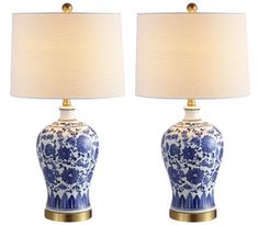 two blue and white vases with lamps on them