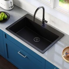 a black kitchen sink sitting on top of a counter