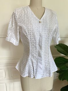 "Vintage 80s Italian eyelet pattern short sleeve blouse. With a button front closure and placket that covers all of them except the top pearl button. Made of bright white cotton, this top is beautifully tailored with visible seams that show off the slightly nipped in waist and flared hem. Label reads \"Enara Camice\" Fits a size small 15\" shoulder 10\" sleeve 34\" bust 28\" waist 24\" length In excellent vintage condition, light wear but no visible holes, stains or flaws." Top Pearl, Eyelet Shorts, Eyelet Blouse, Silky Blouse, Cheongsam Dress, Vintage Italian, Patterned Shorts, Short Sleeve Blouse, Bright White