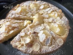 a cake that is on a plate with some powdered sugar on top and one slice missing