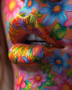 a woman's face painted with colorful paint and flowers on her body is shown