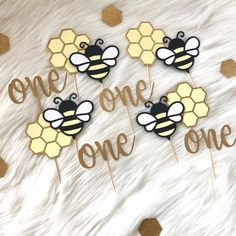 bee themed cupcake toppers with the words one, one, one on them