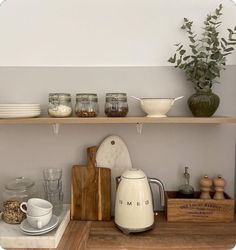 the shelves are filled with dishes, cups and utensils on wooden trays